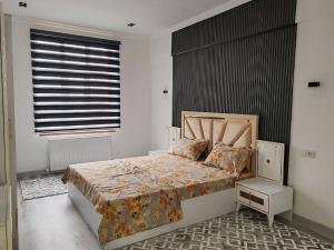 a bedroom with a bed and a window at Snowlight Studio in Toshkent-Passajir Bekati