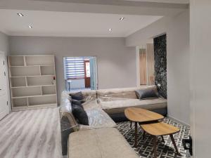 a living room with a couch and a table at Snowlight Studio in Toshkent-Passajir Bekati
