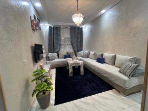 a living room with a couch and a table at Spacious 3BR Apartment Near Akdital in Fès