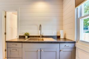 a kitchen with a sink and a window at 3 Mi to Michigan State Tiny Home with Deck! in Lansing +17 photos