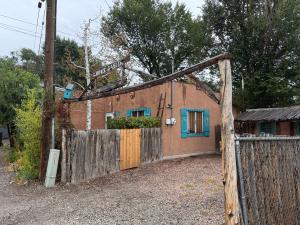 a house with a gate and a fence at Unique Southwest 2-bedroom home Permit #03015 in Alamosa