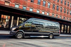 a black bus parked in front of a building at New York shuttles in Brooklyn