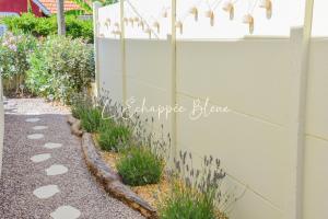 a fence withestones on the side of a garden at L'Échappée Bleue, maison à 200m de la mer pour vacances et travail in Saint-Brevin-les-Pins +38 photos