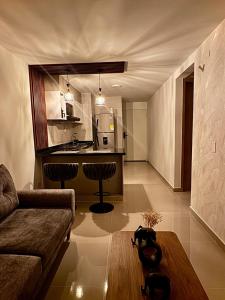 a living room with a couch and a kitchen at paraiso 1909 apto en el centro Cali in Cali