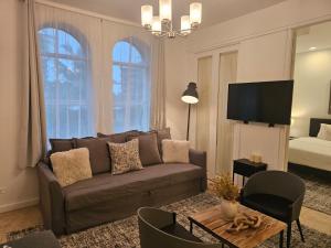 a living room with a couch and a flat screen tv at Bellio in Sobe in Miami Beach