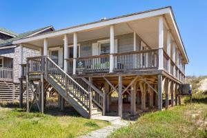 a large house with a porch and a deck at 5050 - Sea Haven in Kill Devil Hills +37 photos