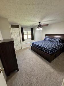 a bedroom with a bed and a ceiling fan at Home Sweet Home Atlanta in Stockbridge