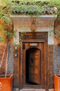 an entrance to a building with a wooden door at Riad Anya & SPA in Marrakech