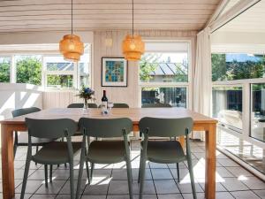 a dining room with a wooden table and chairs at Luxury Spa Retreat in Blavand - By Traum Ferienwohnungen in Blåvand