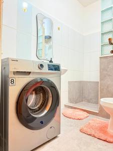 a washing machine in a bathroom with a sink at Charming Apartment in Historic Building-Near Luanda Bay in Luanda +53 photos