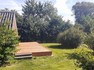 a wooden deck in the middle of a yard at Seaside Rustic Retreat - By Traum Ferienwohnungen in Flovtrup