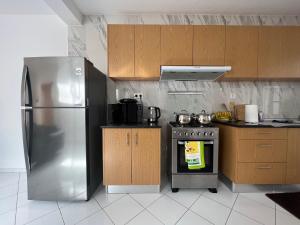 a kitchen with a stainless steel refrigerator and a stove at PIMONTAPARTMENTS in Espargos