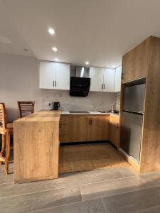 a kitchen with wooden cabinets and a refrigerator at Coral Cove in Flic-en-Flac +20 photos