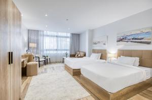 a hotel room with two beds and a desk at AL Farida Boutique Pyramids in Cairo