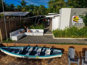 two people sitting on a boat on a patio at Tortuguero7 lake view in Tortuguero