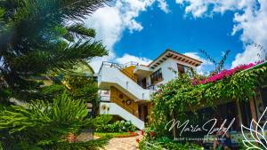 a building with flowers on the side of it at Hotel María Isabel Ataco in Concepción de Ataco