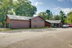 a barn with a car parked in a parking lot at Outdoor Wet Bar Spacious Eagle River Retreat! in Eagle River