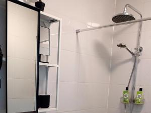 a shower with a glass door in a bathroom at Kolibrie in Dirkshorn +42 photos