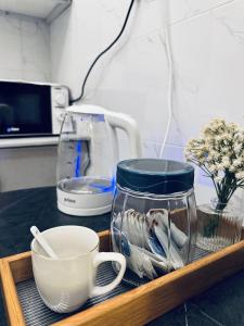 a tray with a coffee mug and a cup on a counter at Modern Apartment in Jeddah