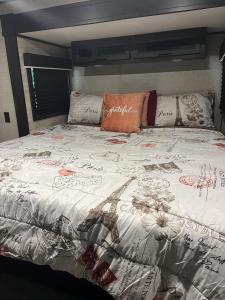 a large bed with a comforter and pillows on it at Glamping at Double S Farms in Spring Hill