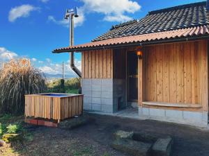 a small house with a hot tub in front of it at その火暮らし Sonohigurashi - Life with Fire Guesthouse in Yamano +41 photos