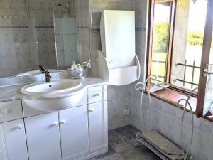 a bathroom with a sink and a mirror at Gîte familial calme avec jardin, wifi et équipements bébé, animaux acceptés - FR-1-584-92 in Saint-Germain +28 photos