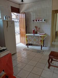 una cocina con una mesa y un refrigerador en Casa de Praia em Mosqueiro, en Belém