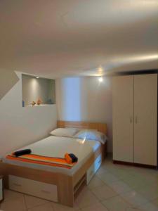 a bedroom with a bed and a white cabinet at Apartments with parking space Trpanj, Peljesac - 15976 in Trpanj
