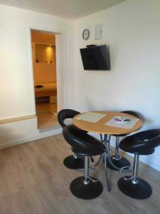 a room with a table and chairs and a television at Apartments with parking space Trpanj, Peljesac - 15976 in Trpanj