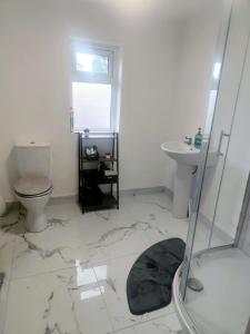 a bathroom with a toilet and a sink at Kelly's Country Cottage in Rookwood +27 photos