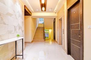 a hallway of a house with a door and stairs at Super Hotel O SAMOTEL in kolkata