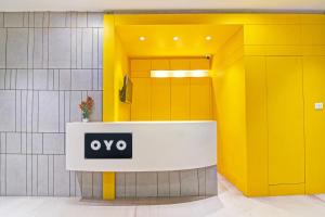 a yellow and white lobby with a yes sign at Super Hotel O SAMOTEL in kolkata +22 photos