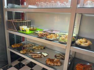 a display case filled with different types of food at Mundial Hotel in Goiânia +21 photos