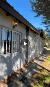 a white house with a white arrow on it at Family Home en Costa Azul in Costa Azul