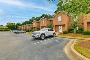 a car parked in a parking lot in front of houses at 2 Mi to Tiger Territory! Condo with Community Pool in Auburn