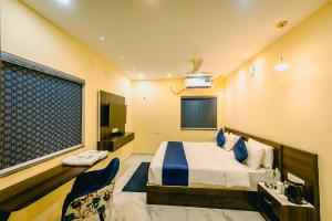 a hotel room with a bed and a television at Livotel Premium Hotel in Bhubaneshwar +112 photos