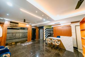 a lobby with a reception desk and chairs at Livotel Premium Hotel in Bhubaneshwar