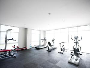 a gym with several treadmills and machines in a room at Family room in Baan Pakdi Pattaya in Pattaya Central