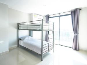 a bunk bed in a room with a window at Family room in Baan Pakdi Pattaya in Pattaya Central +20 photos