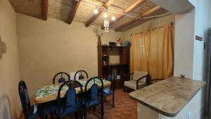 a kitchen and dining room with a table and chairs at Depto Emma in Fiambala