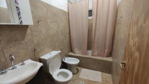 a bathroom with a toilet and a sink at Depto Emma in Fiambala