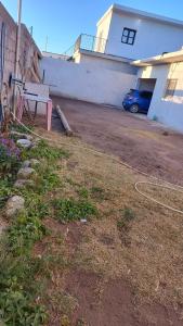 a yard with a bench in front of a house at Depto Emma in Fiambala