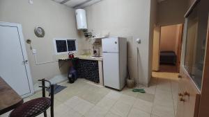 a kitchen with a white refrigerator and a sink at Depto Emma in Fiambala +1 photo