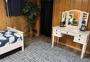 a bedroom with a bed and a dresser with a mirror at Spacious 5BR Arlington Home with Parking & Yard - Woodrow in Arlington
