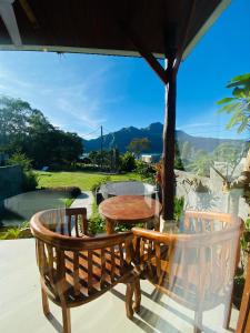 库布盼洛坎senja bali kintamani的美景门廊上的一张桌子和两把椅子