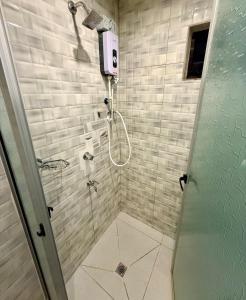 a bathroom with a shower with a glass door at RN Homestay Nadi Fiji in Nadi International Airport