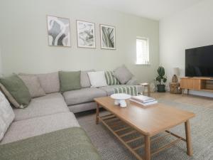 a living room with a couch and a coffee table at Kerrek Lodge in Falmouth