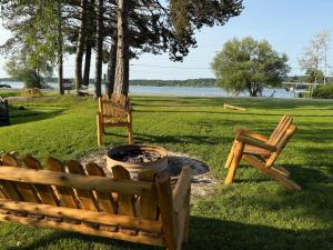 two chairs and a fire pit in a park at Eddys Motel in East Jordan