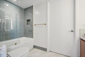 a bathroom with a tub and a toilet and a sink at NEW Luxury Bay View Downtown 1 Bedroom in Miami