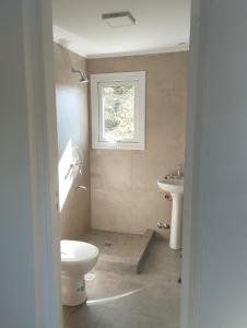 a bathroom with a toilet and a sink at Wangülén in San Carlos de Bariloche